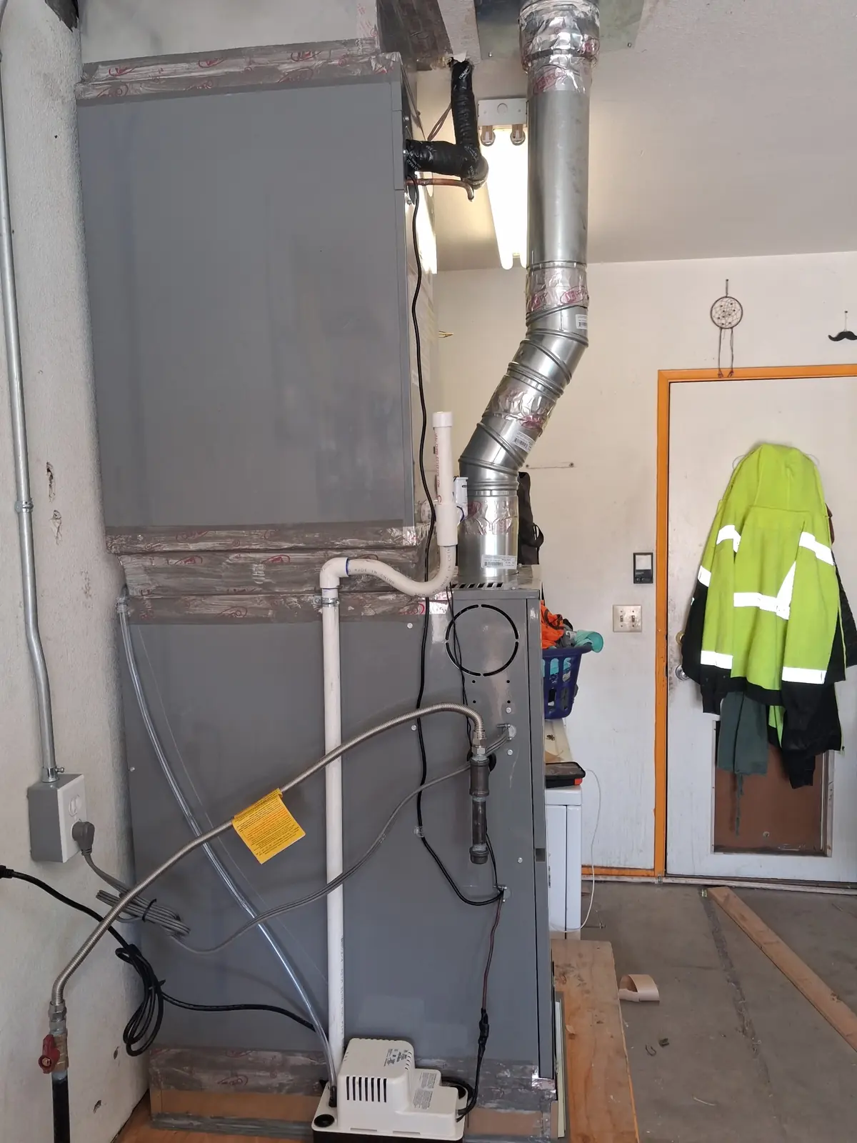 Gas furnace and air handler installed in a utility room