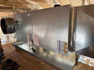 Air handler and duct connections installed in a new-construction attic