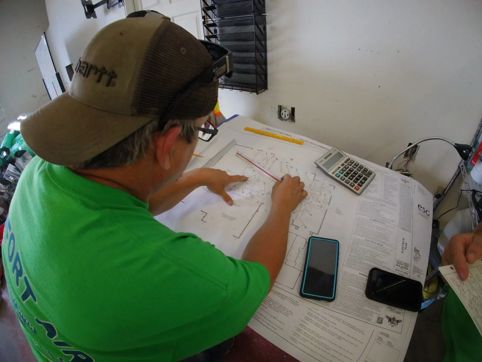Technician reviewing plans before work begins