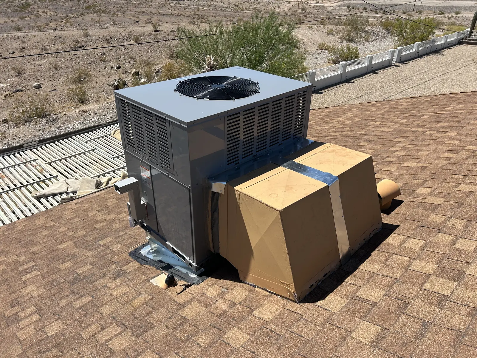 New packaged rooftop unit set on a home roof