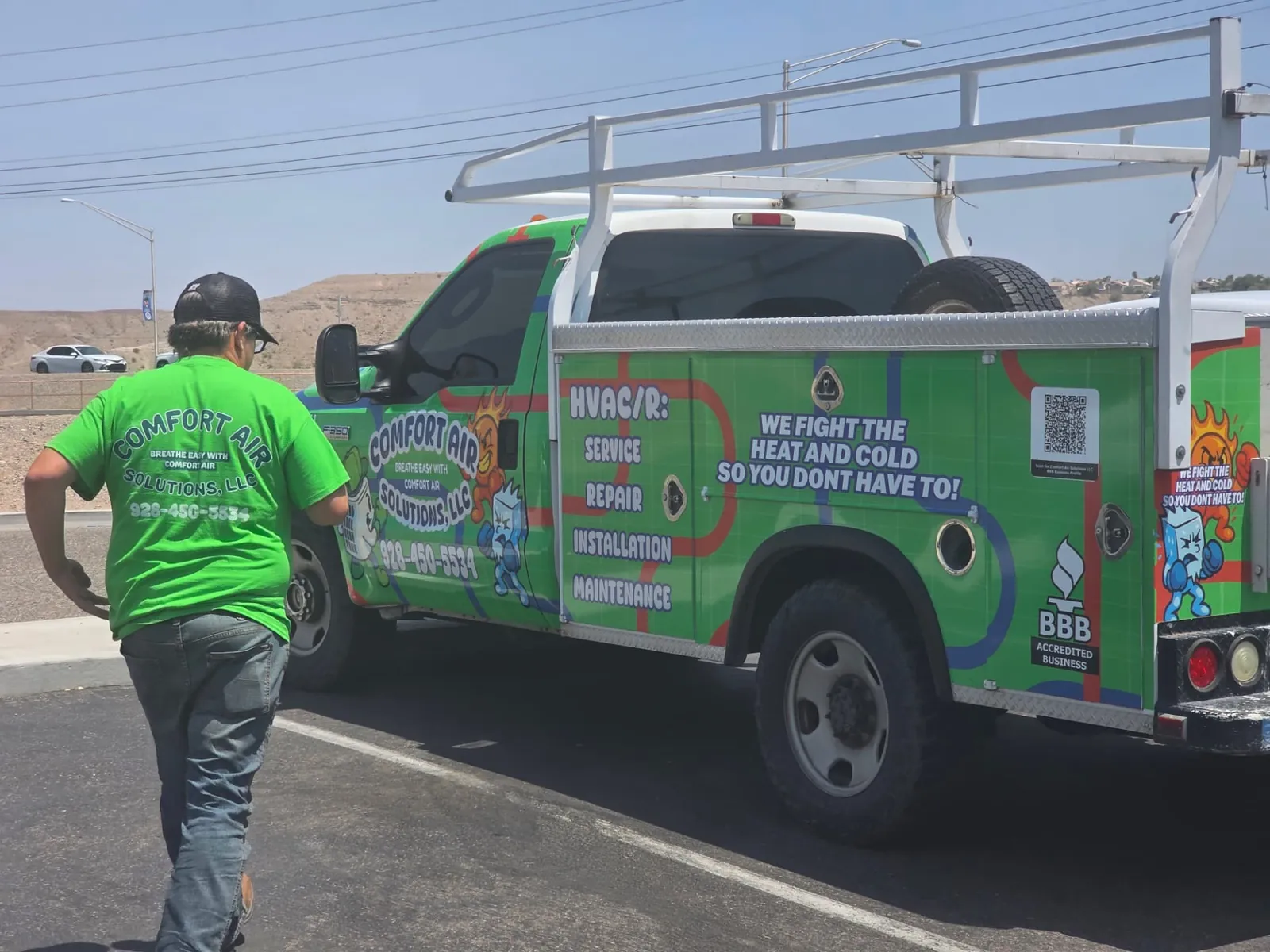 Comfort Air Solutions branded service truck in Mohave County with a technician walking up to it