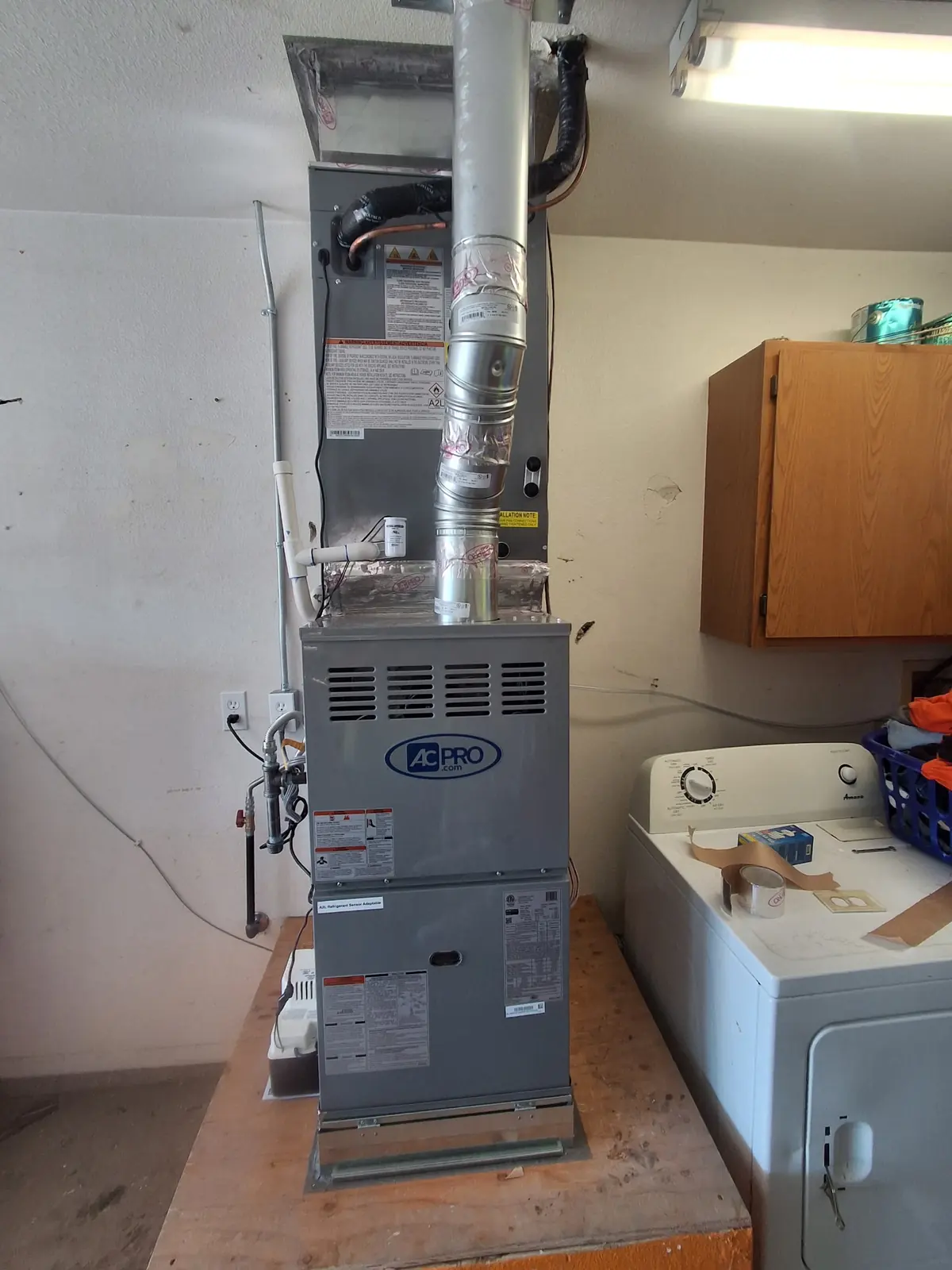Residential furnace installed beside a washer and dryer