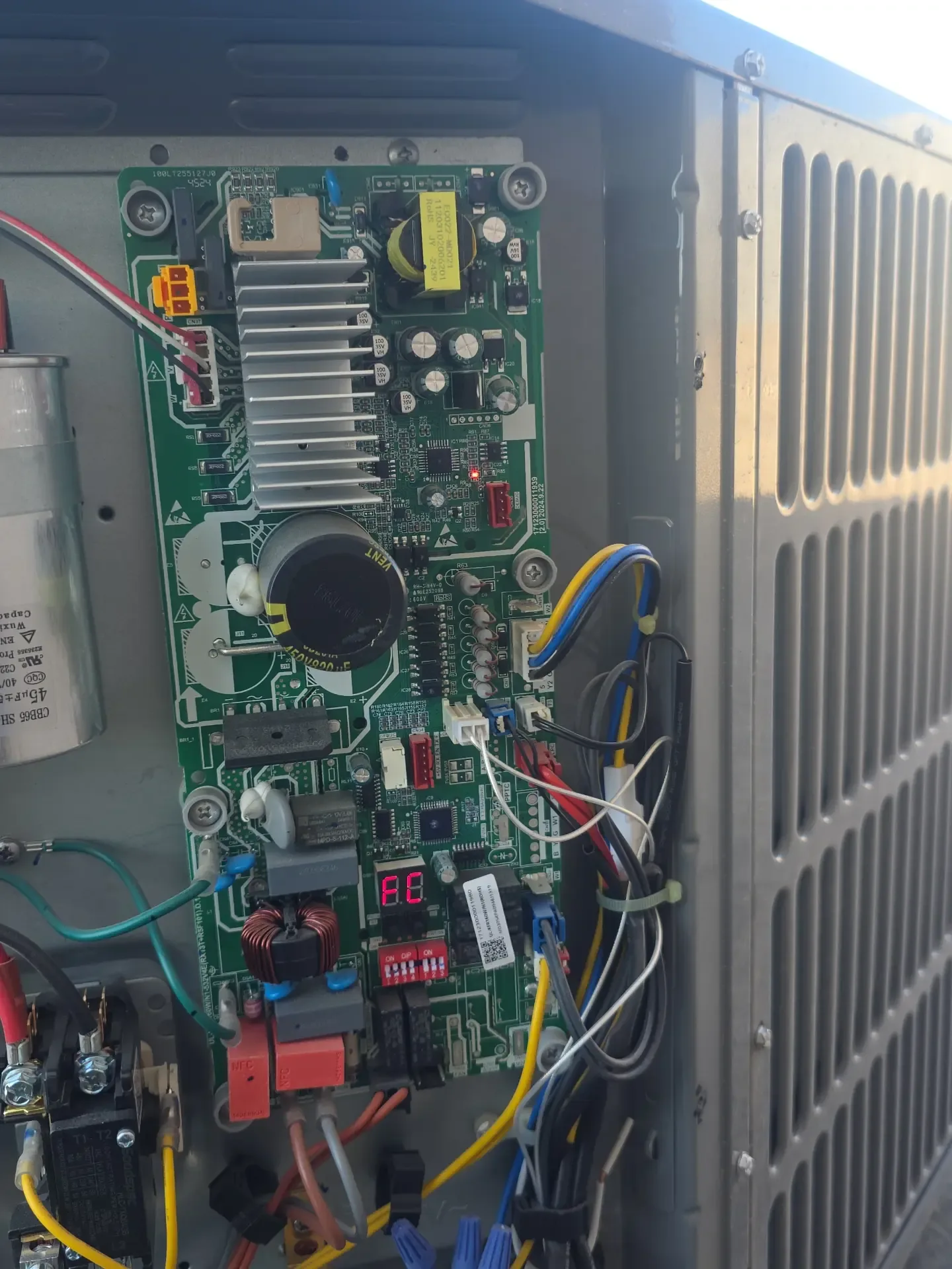 Outdoor unit control board showing a fault code on its display