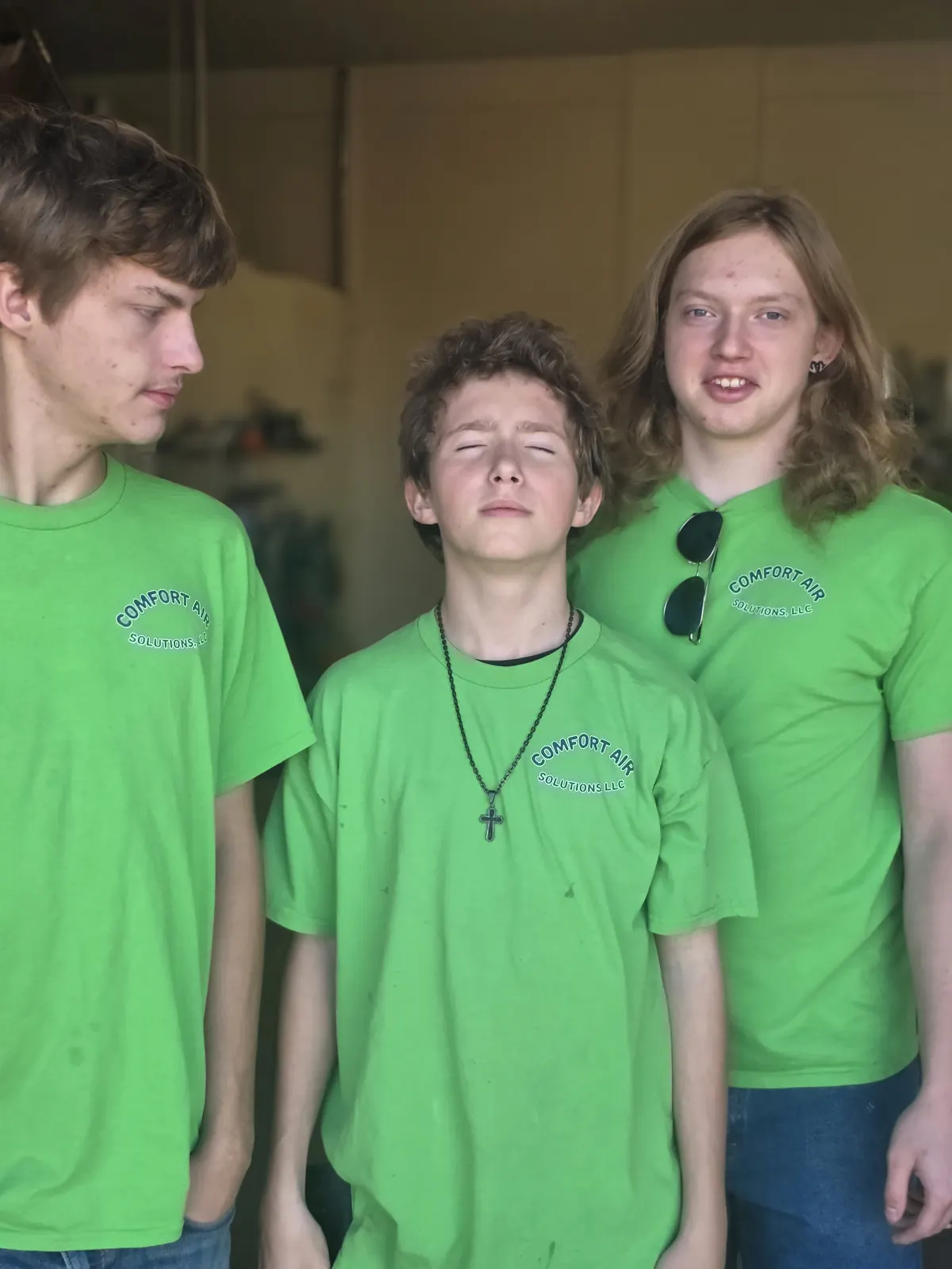 Comfort Air Solutions technicians in company shirts at the shop