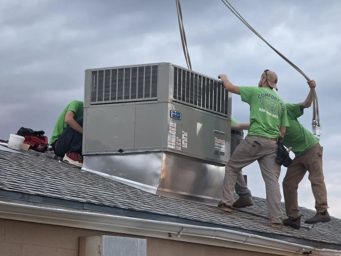 CAS crew setting a rooftop package unit on a Mohave County home