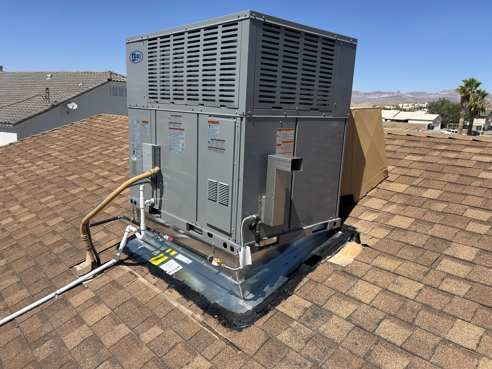 Packaged rooftop air conditioning unit set on a home roof