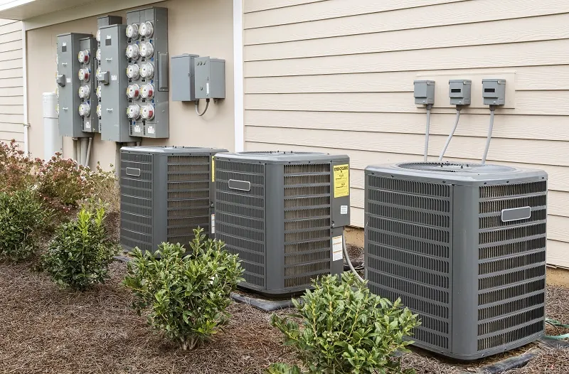 Bank of outdoor condensing units beside a building