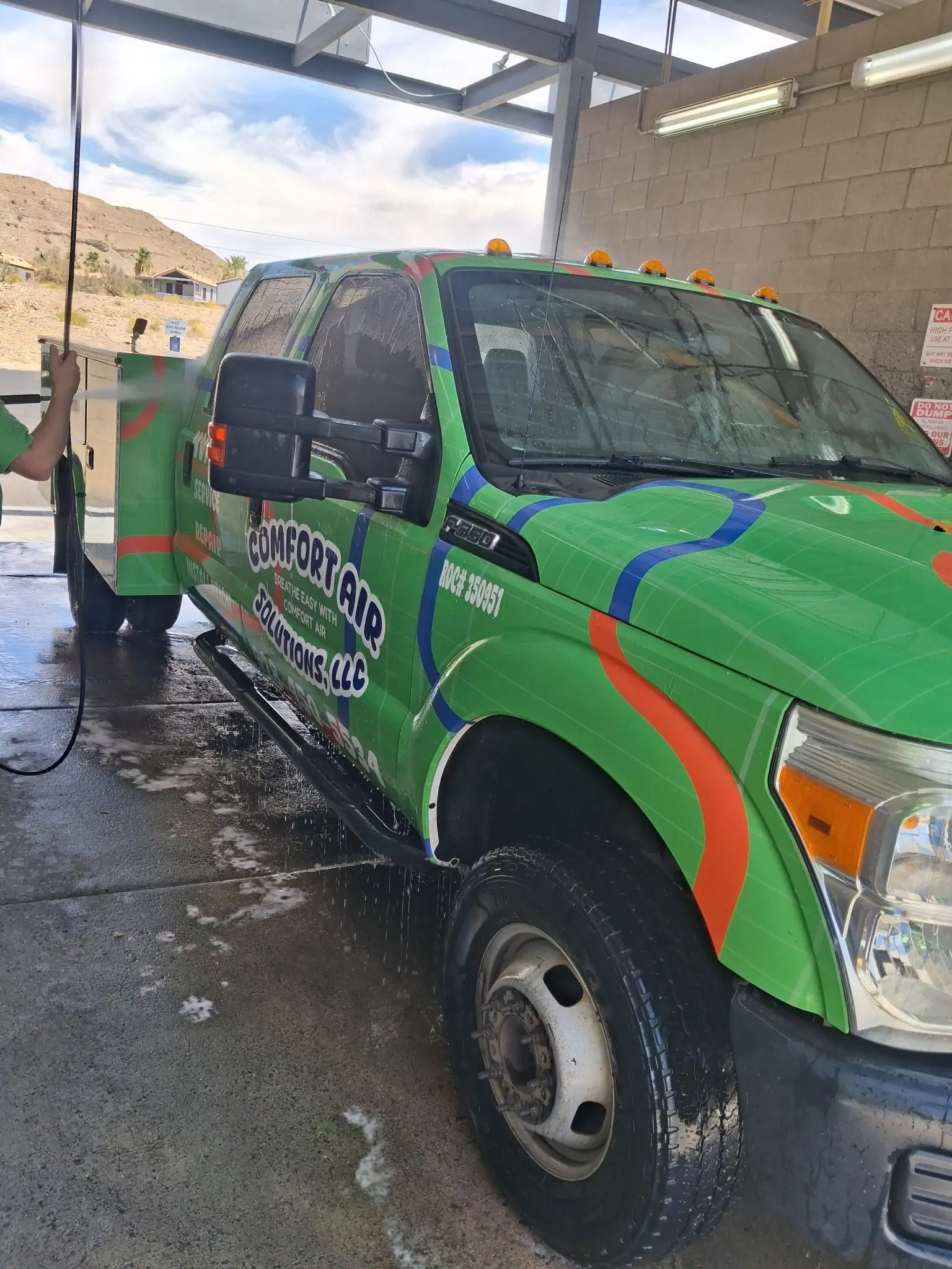 Comfort Air Solutions service truck being washed at the shop bay
