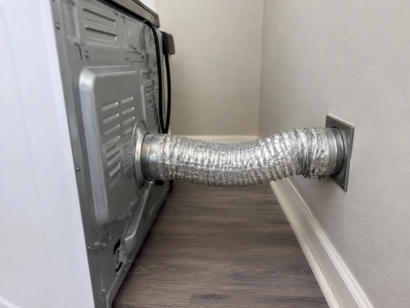Foil transition duct connecting the back of a dryer to the wall vent