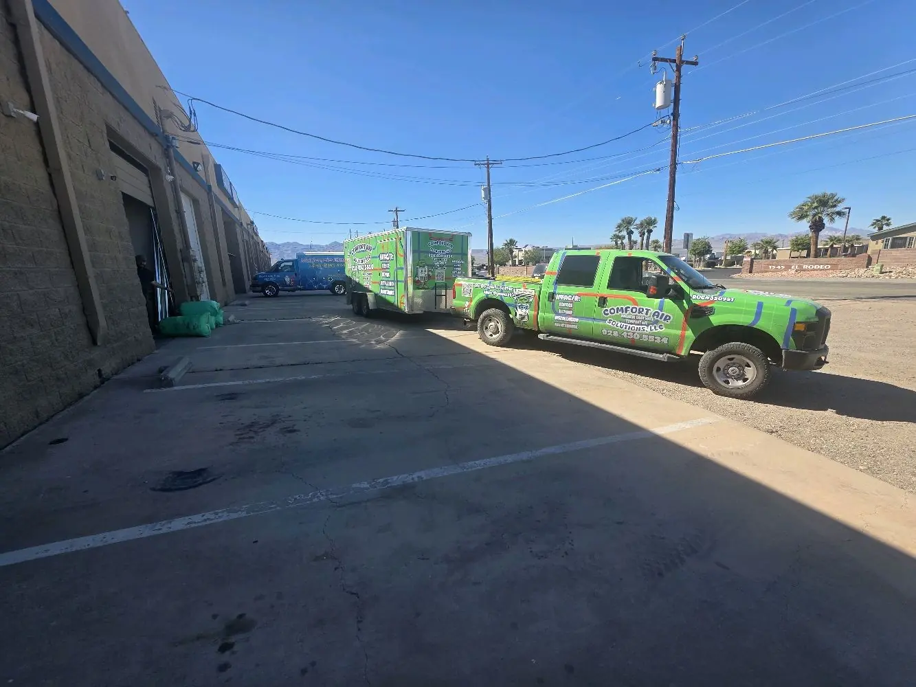 Comfort Air Solutions truck and trailer parked at a commercial building