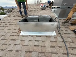 Comfort Air Solutions crew setting a rooftop curb on a commercial building